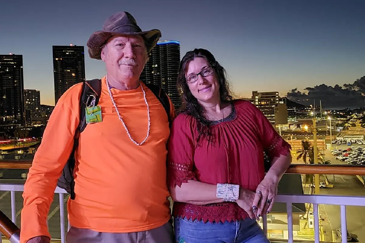 Couple posing with wrist wallet outdoors